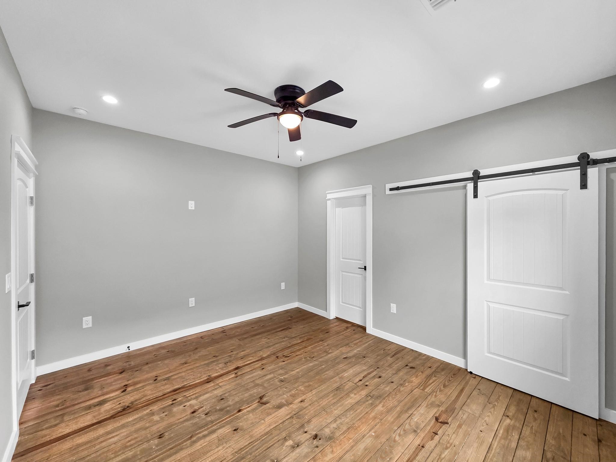 1041 Sunset Circle Crystal Beach, TX 77650 - Photo 31 of 45 a view of empty room with wooden floor and fan
