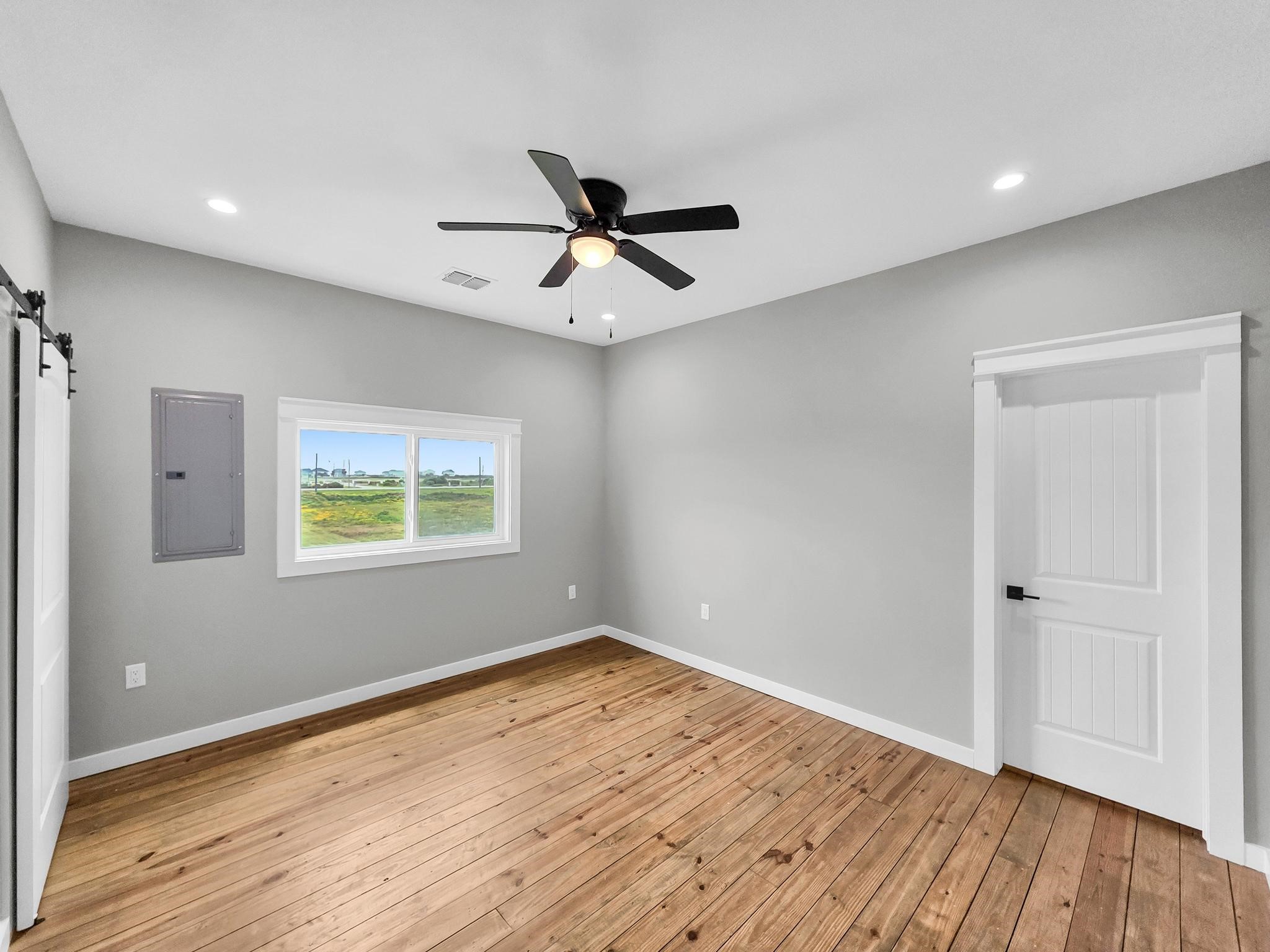 1041 Sunset Circle Crystal Beach, TX 77650 - Photo 33 of 45 wooden floor in an empty room with a window