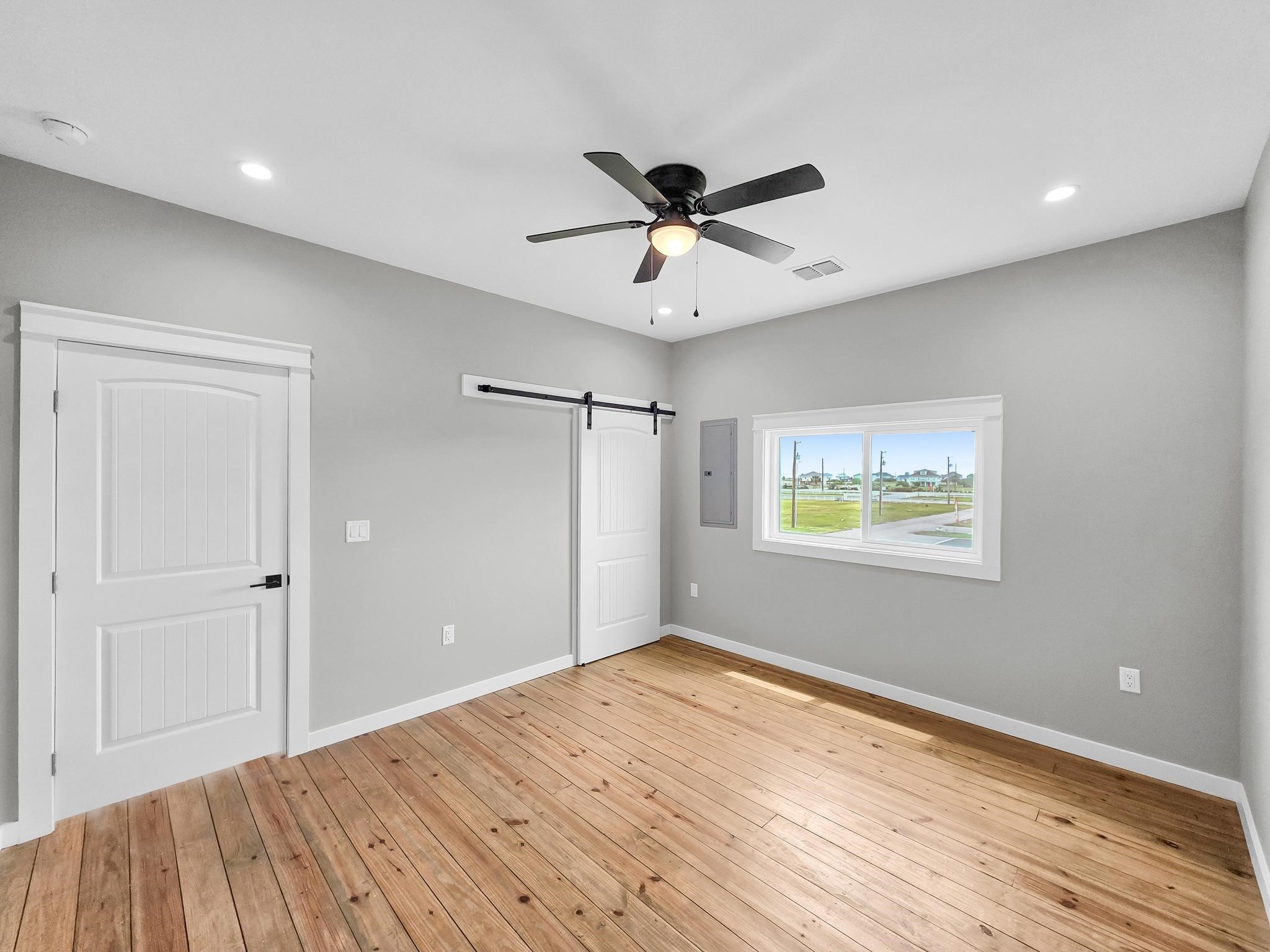 1041 Sunset Circle Crystal Beach, TX 77650 - Photo 34 of 45 a view of empty room with wooden floor and fan