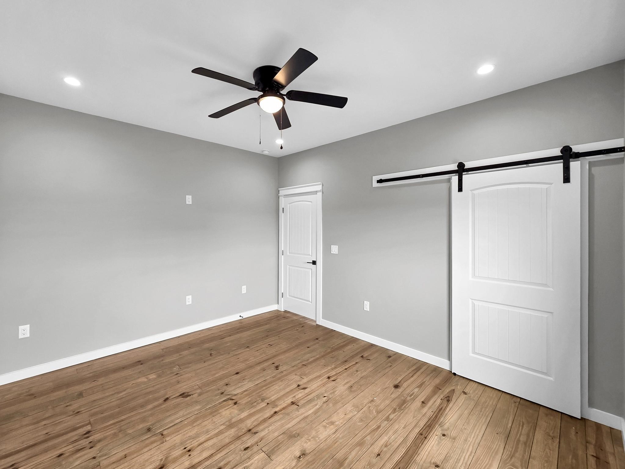 1041 Sunset Circle Crystal Beach, TX 77650 - Photo 35 of 45 a view of an empty room with wooden floor and a ceiling fan