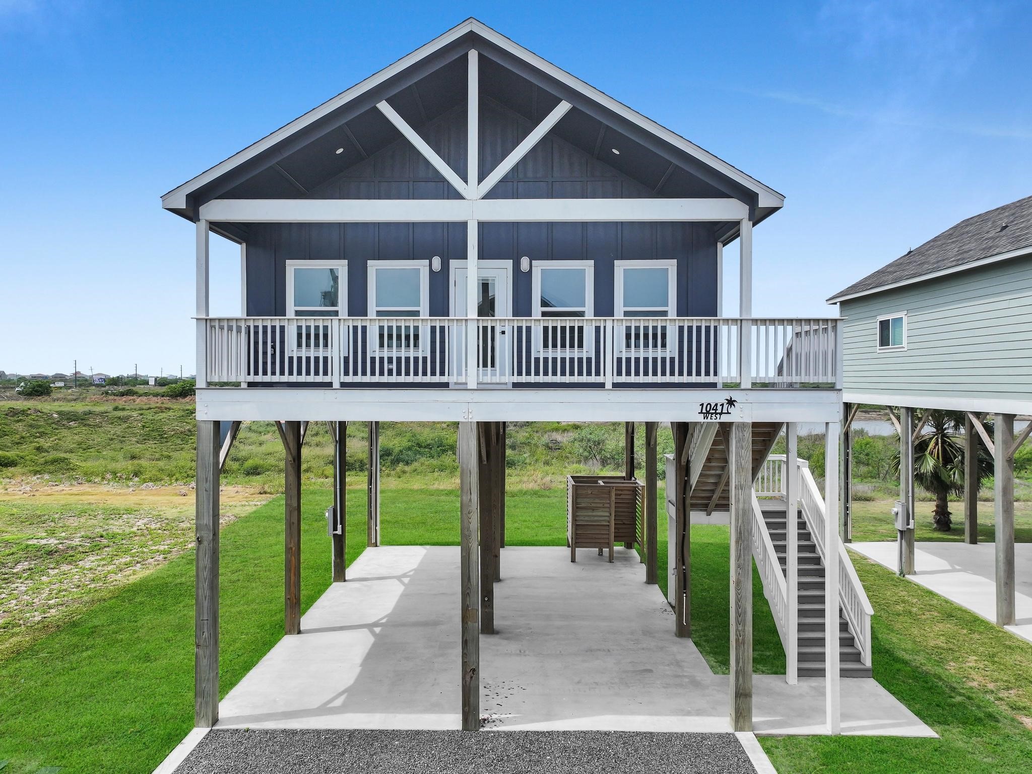 1041 Sunset Circle Crystal Beach, TX 77650 - Photo 4 of 45 a front view of a house with a yard table and chairs