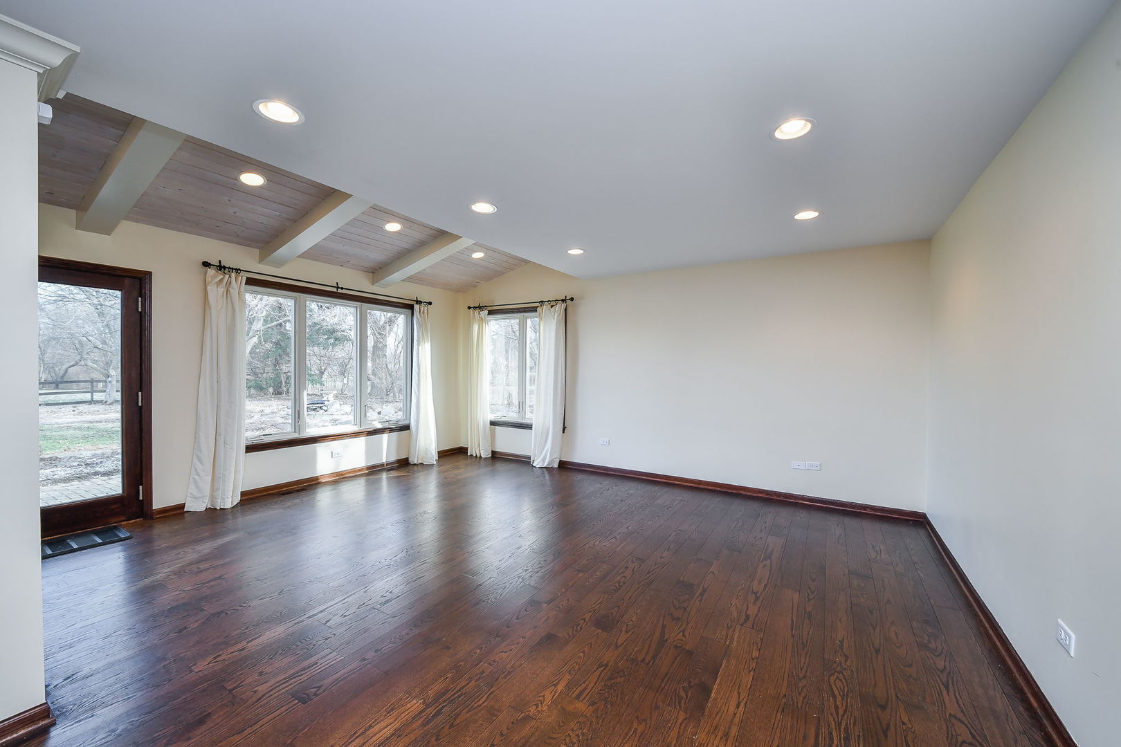 42W420 Campton Hills Road Elburn, IL 60119 - Photo 9 of 58 a view of an empty room with wooden floor and windows
