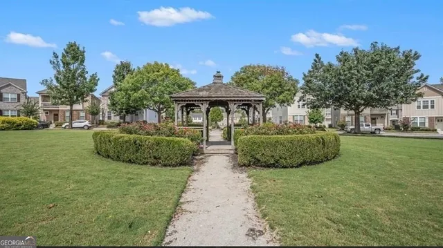 a view of a garden with a house