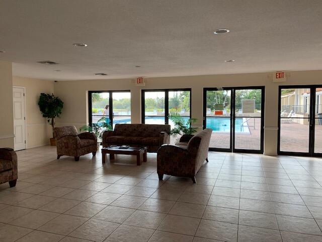 4154 Inverrary Drive, Unit 407 Lauderhill, FL 33319 - Photo 37 of 39 a living room with furniture and large windows
