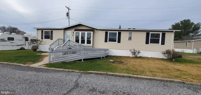 a front view of a house with a yard outdoor seating and barbeque oven