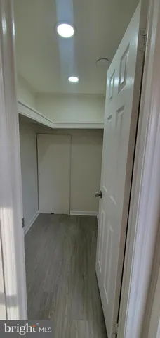 a view of hallway with wooden floor