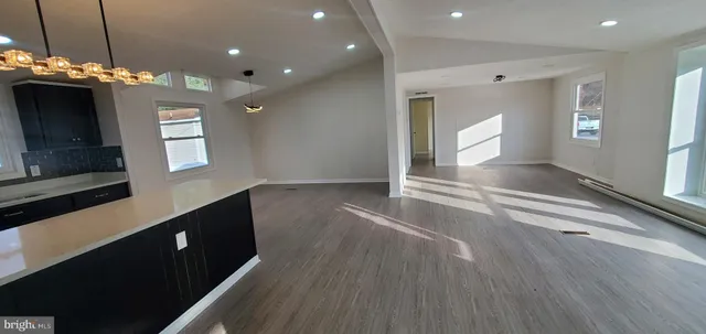 a view of a hallway with windows and chandelier