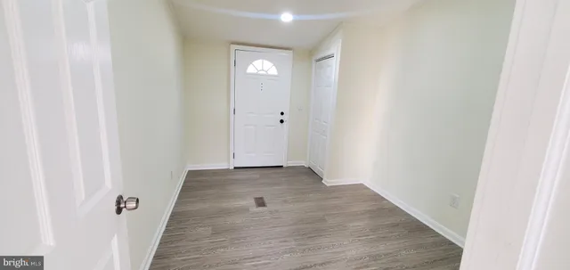a view of a hallway with wooden floor