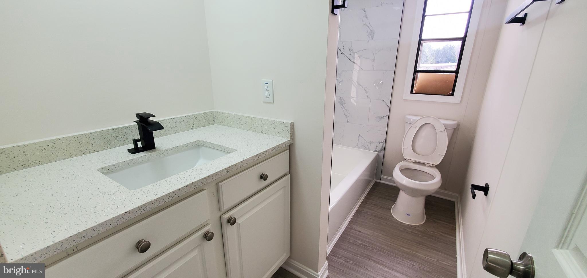 35-1125 Old Philadelphia Road Aberdeen, MD 21001 - Photo 16 of 18 a bathroom with a sink a toilet and a mirror