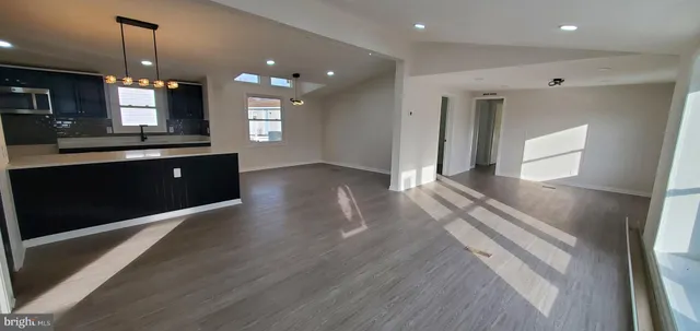 a spacious bathroom with a sink a large mirror and vanity