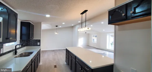 a kitchen with a sink a counter space and stainless steel appliances