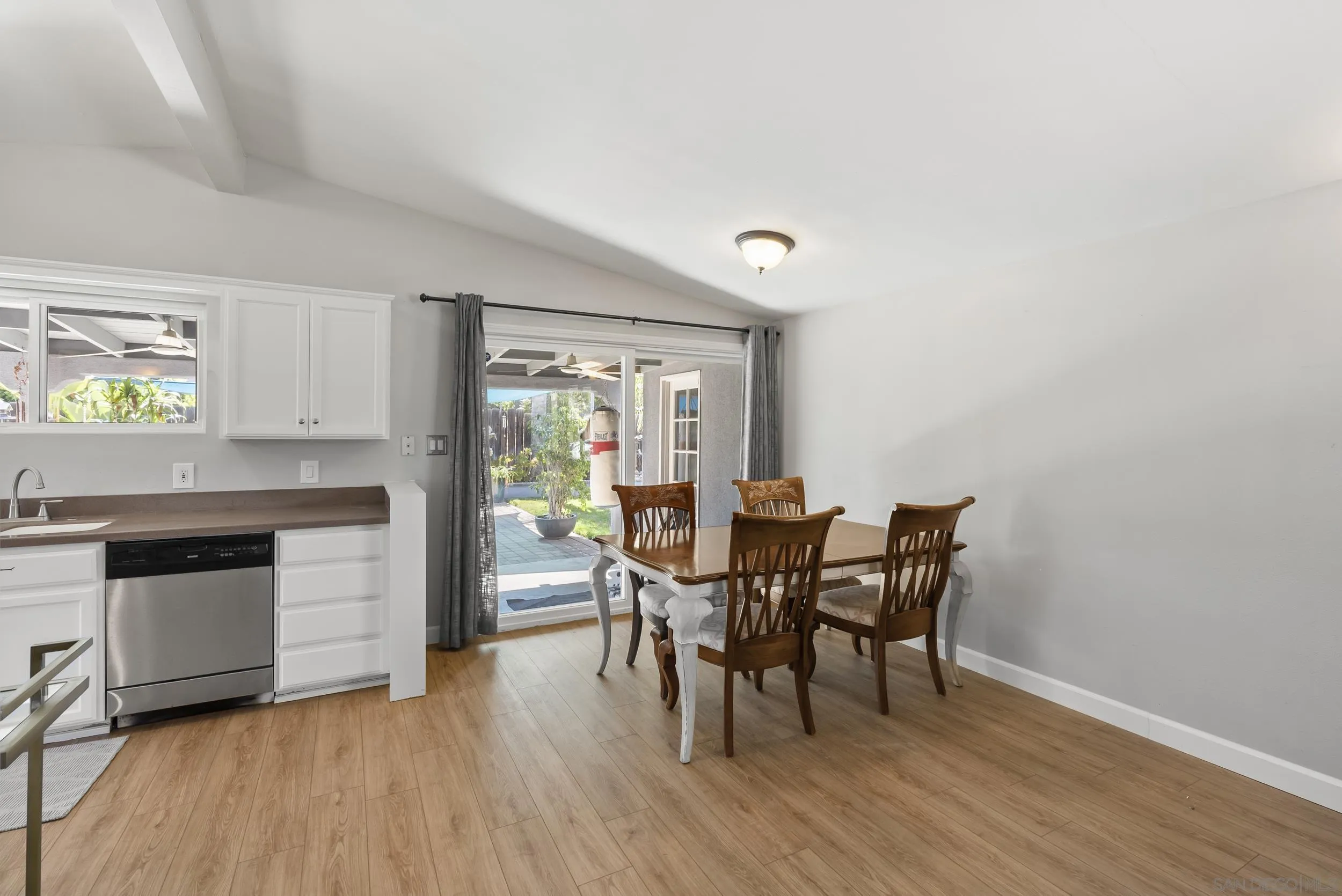 13425 Powers Road Poway, CA 92064 - Photo 8 of 35 a view of a dining room with furniture and wooden floor
