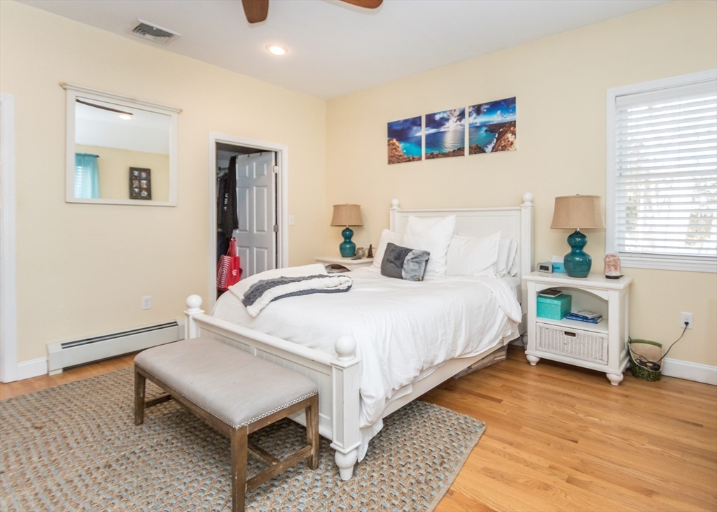 27 Sherman Street Needham, MA 02494 - Photo 11 of 32 a bedroom with a bed and wooden floor