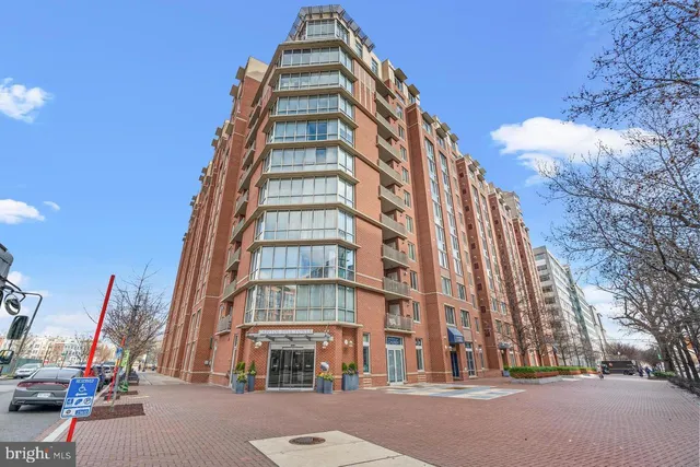 a view of a tall building next to a road