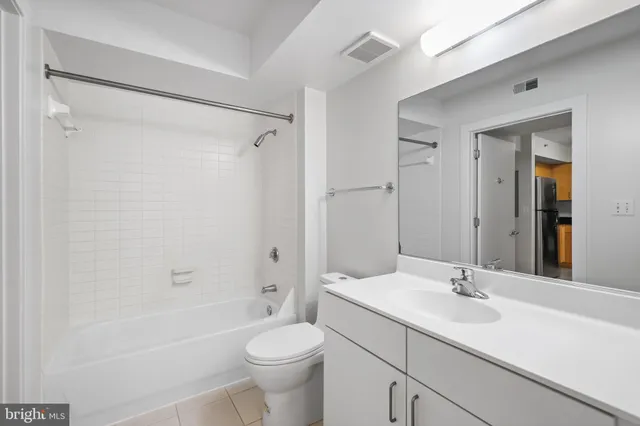a bathroom with a sink toilet a mirror and shower