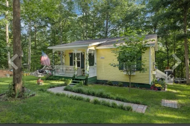 a view of a house with a yard and sitting area