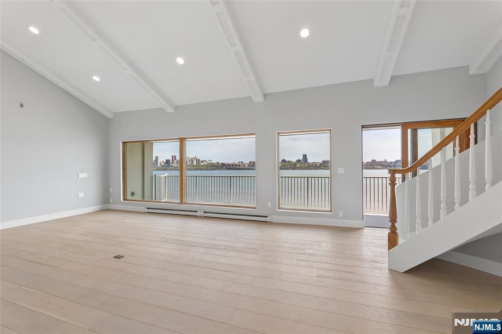 1225 River Road, Unit 4D Edgewater, NJ 07020 - Photo 20 of 47 a view of an empty room with wooden floor and a window