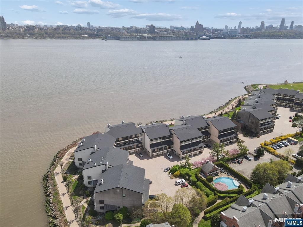 1225 River Road, Unit 4D Edgewater, NJ 07020 - Photo 37 of 47 an aerial view of a house with a lake