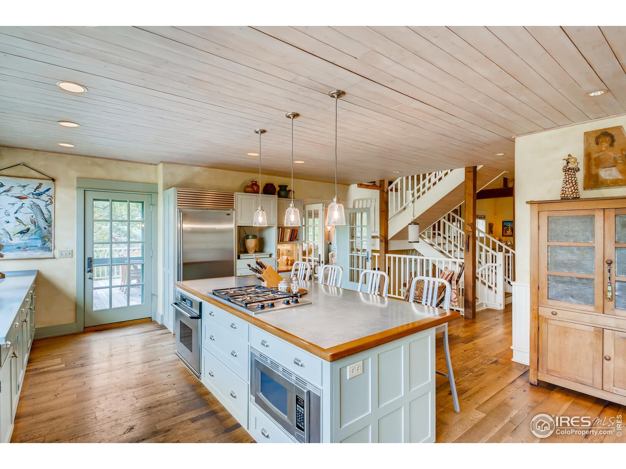 2123 4th Street Boulder, CO 80302 - Photo 11 of 40 a view of living room and kitchen with furniture wooden floor and windows