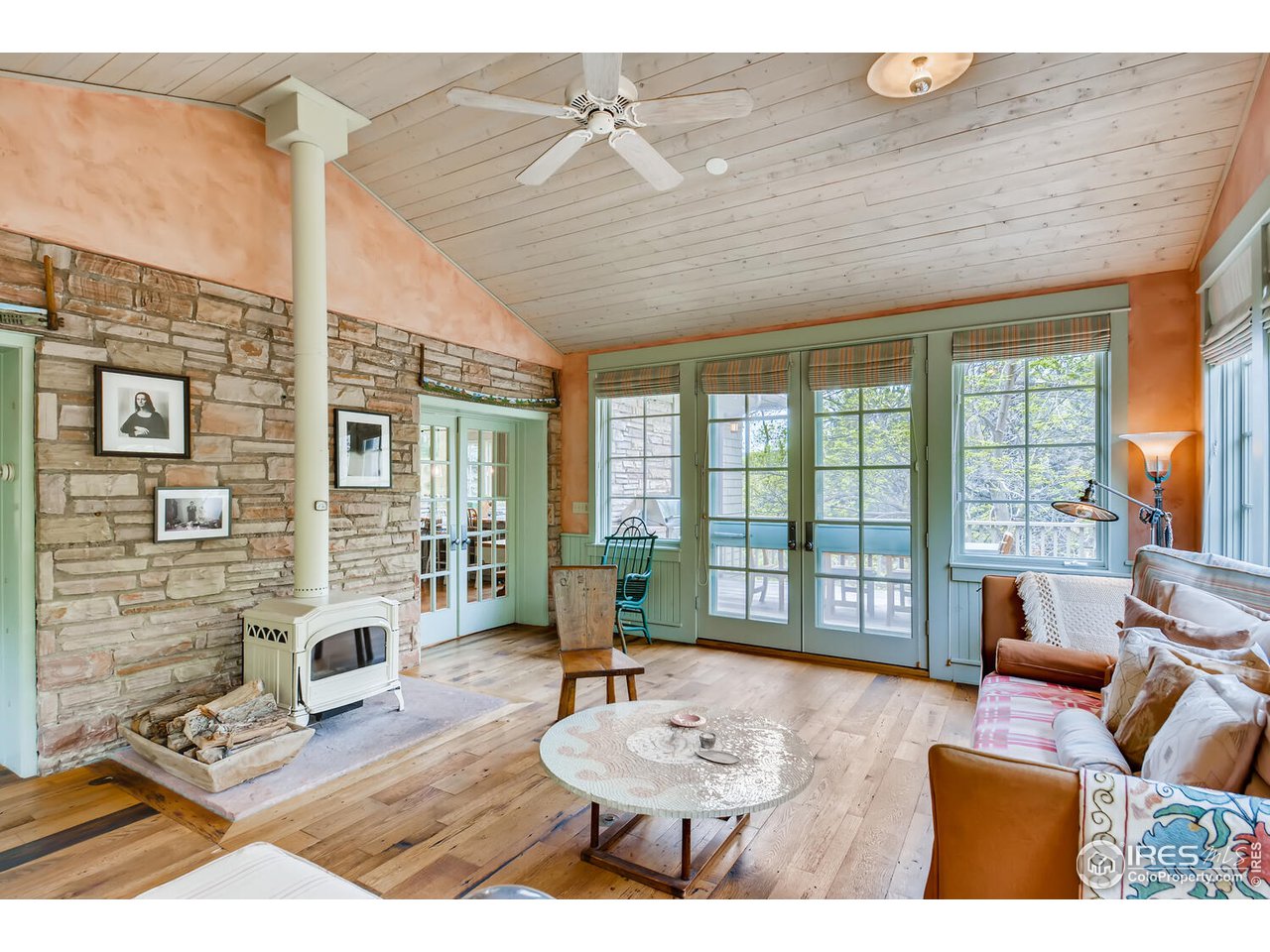 2123 4th Street Boulder, CO 80302 - Photo 13 of 40 a living room with fireplace furniture and a wooden floor