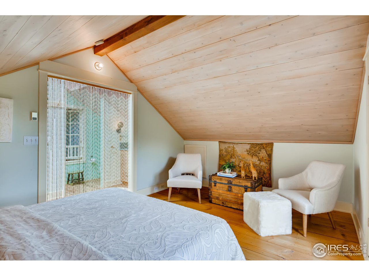 2123 4th Street Boulder, CO 80302 - Photo 16 of 40 a bedroom with furniture and a chair