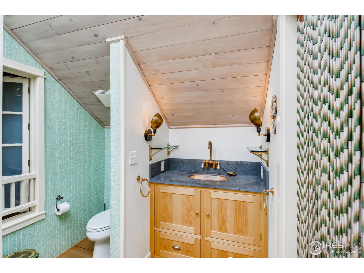 2123 4th Street Boulder, CO 80302 - Photo 17 of 40 a bathroom with a granite countertop sink and a mirror
