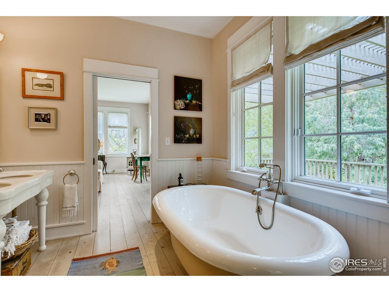 2123 4th Street Boulder, CO 80302 - Photo 22 of 40 a bathroom with a sink a vanity and a large mirror