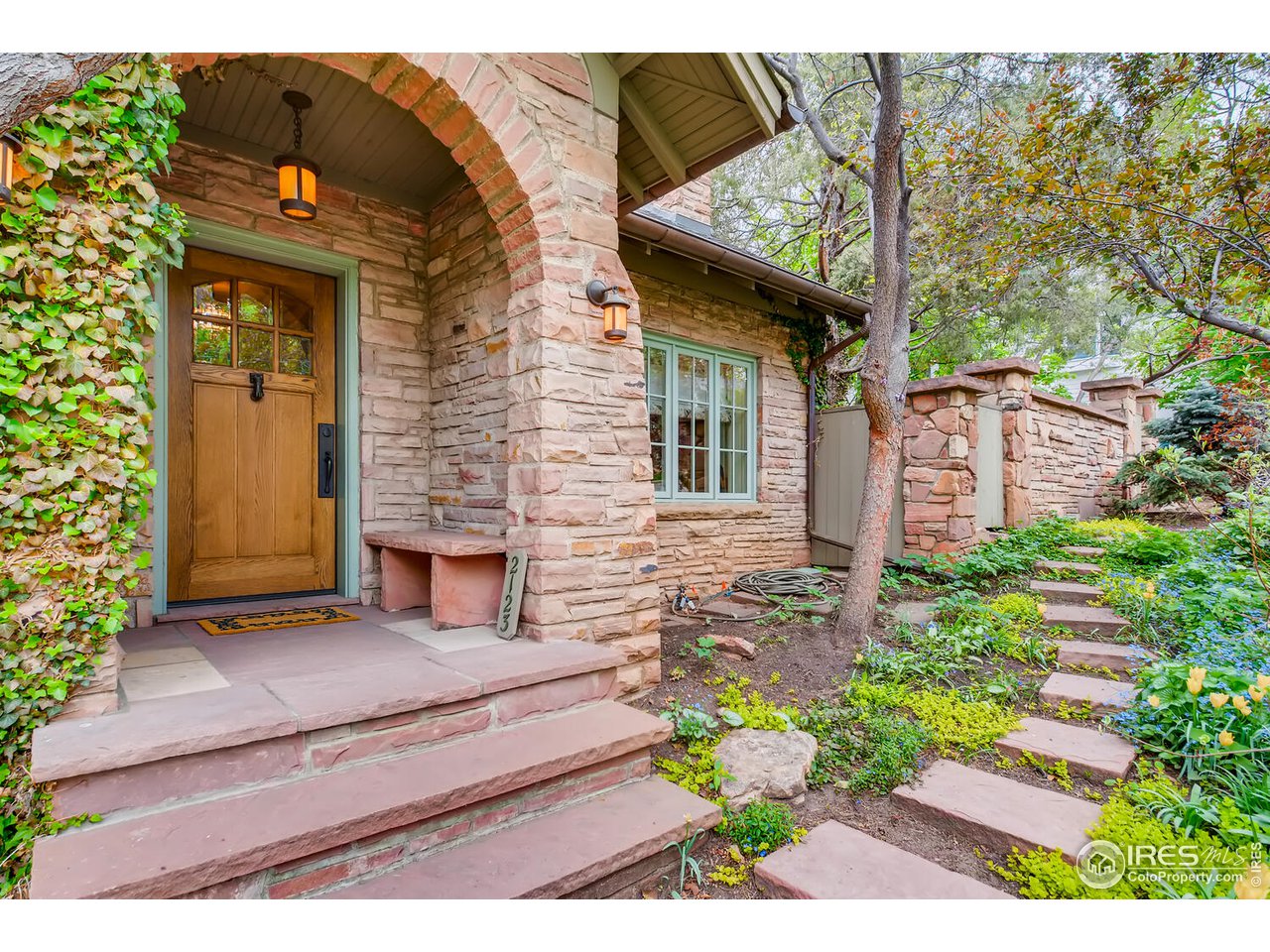 2123 4th Street Boulder, CO 80302 - Photo 3 of 40 a front view of a house with a garden