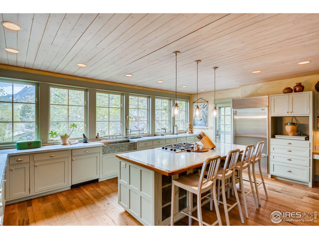 2123 4th Street Boulder, CO 80302 - Photo 8 of 40 a open kitchen with stainless steel appliances granite countertop a stove and white cabinets