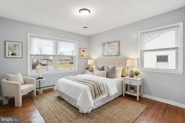 a bedroom with a bed wooden floor and a window
