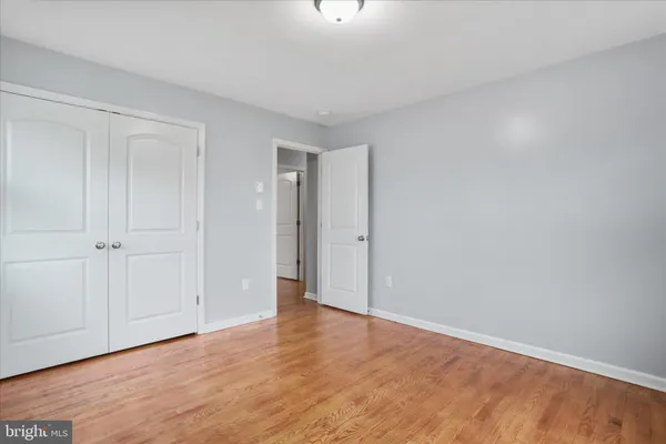 a view of an empty room and wooden floor