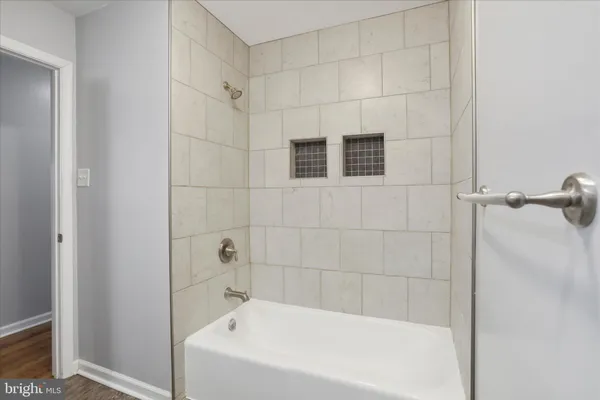a bathroom with a bathtub and shower