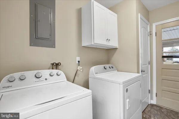 a view of washer and dryer with white cabinet