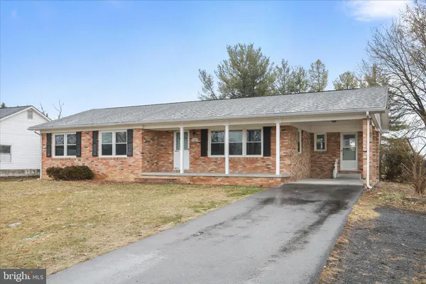 a front view of a house with a garden and yard