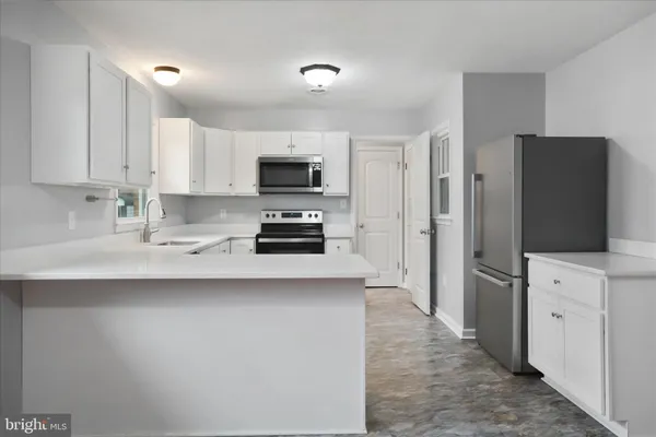 a kitchen with stainless steel appliances a refrigerator stove and sink