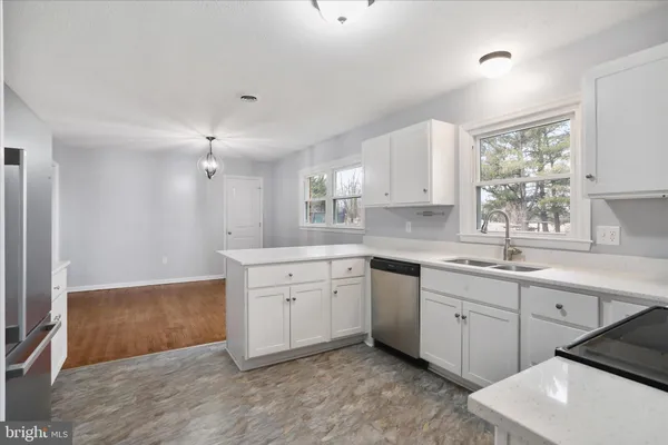 a spacious bathroom with a granite countertop sink mirror and a bathtub
