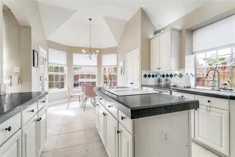 a kitchen with granite countertop a sink and a stove