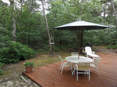 160 Old Long Pond Road Wellfleet, MA 02667 - Photo 8 of 18 an outdoor space with furniture and umbrella