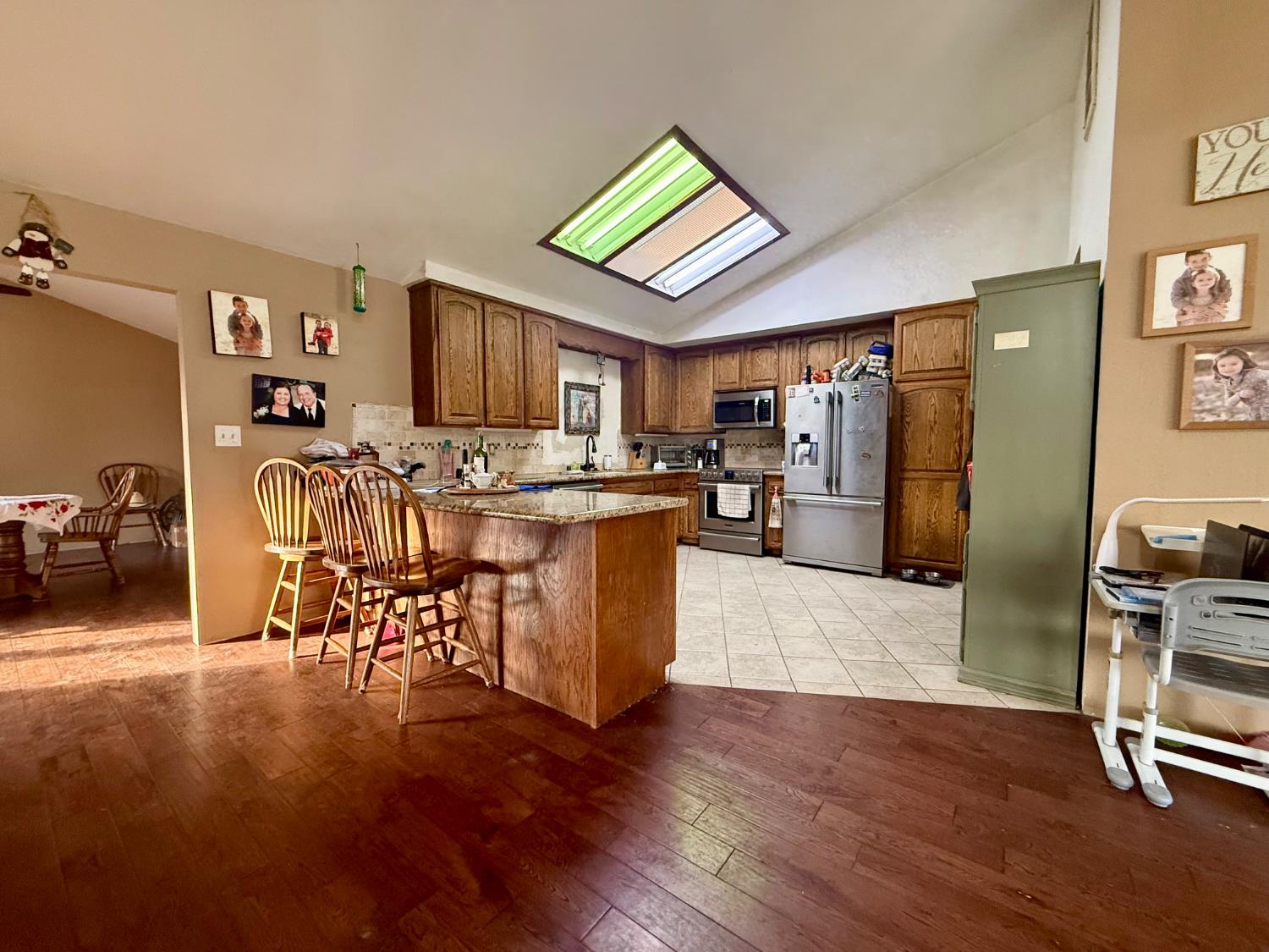 3536 Burson Road Valley Springs, CA 95252 - Photo 18 of 91 a living room with furniture a wooden floor and a kitchen