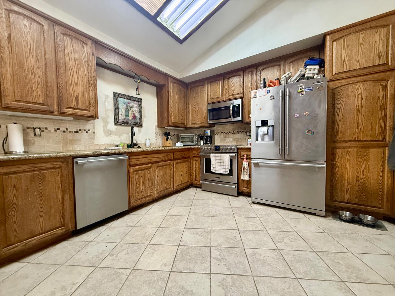 3536 Burson Road Valley Springs, CA 95252 - Photo 21 of 91 a kitchen with stainless steel appliances a refrigerator sink and cabinets