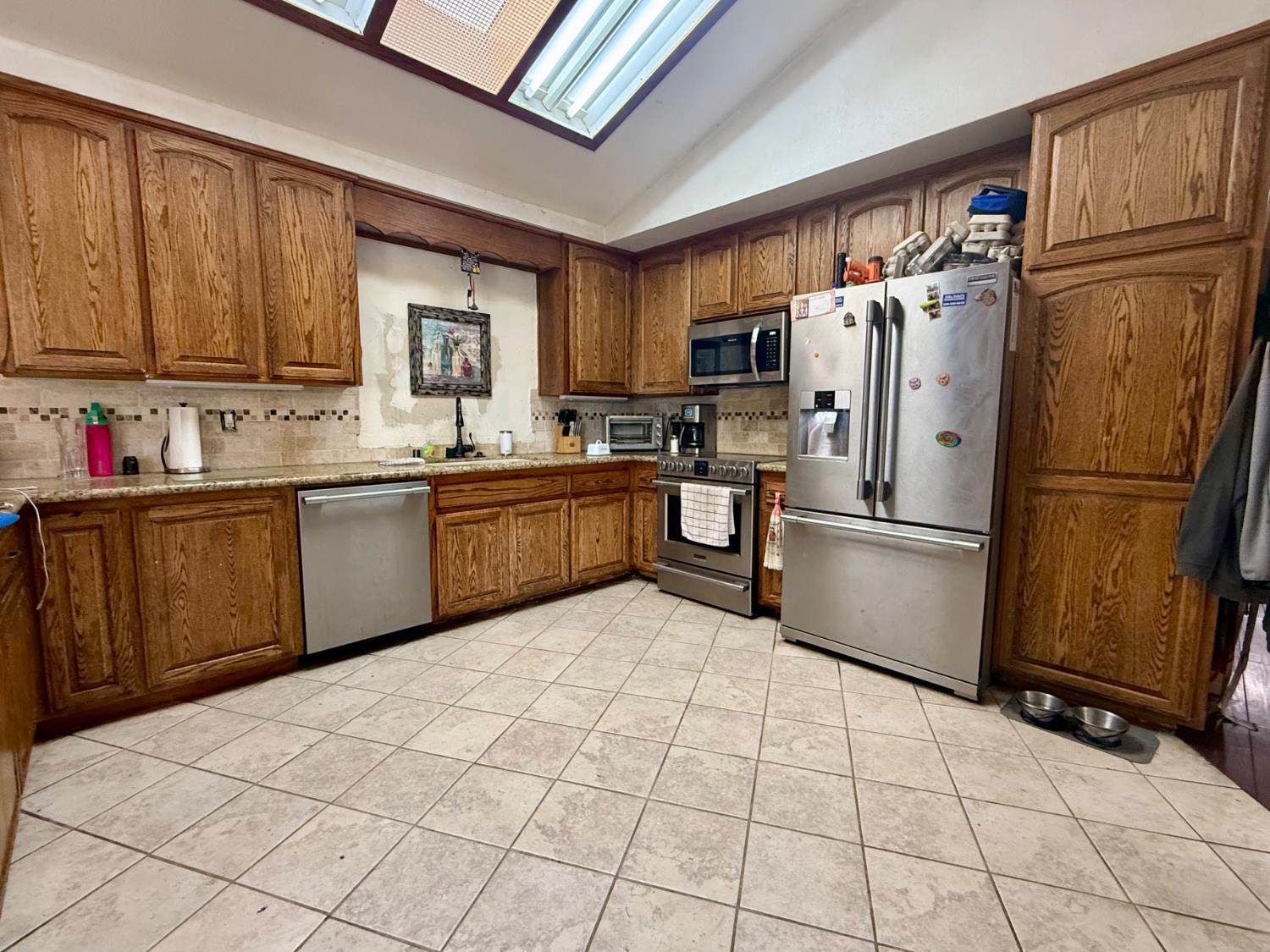3536 Burson Road Valley Springs, CA 95252 - Photo 23 of 91 a kitchen with stainless steel appliances a refrigerator sink and cabinets