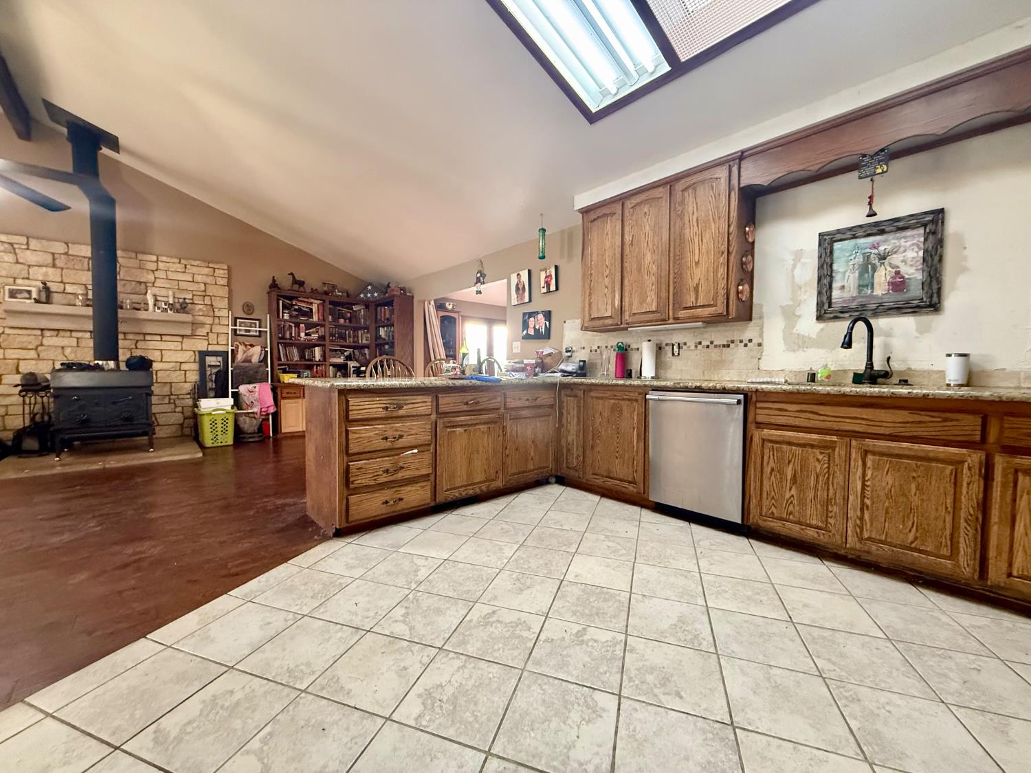 3536 Burson Road Valley Springs, CA 95252 - Photo 24 of 91 a kitchen with stainless steel appliances granite countertop a sink counter space cabinets and a large window