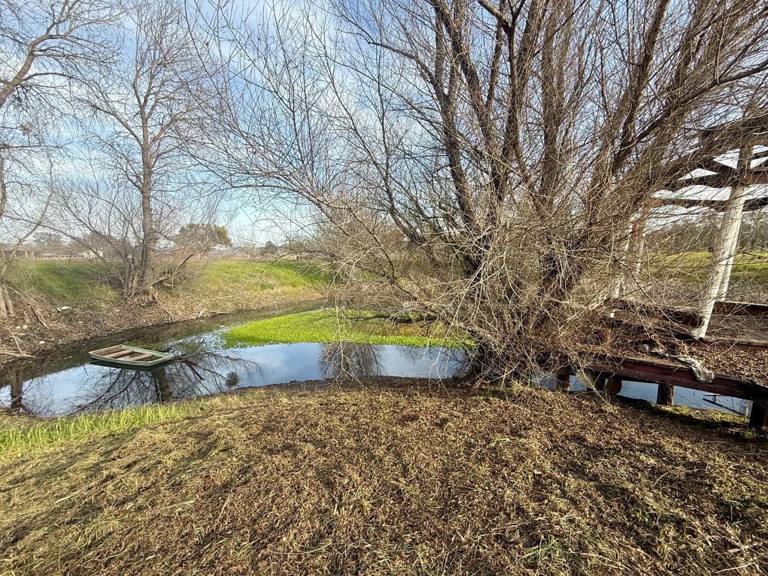 3536 Burson Road Valley Springs, CA 95252 - Photo 70 of 91 a view of a backyard with lawn chairs under an umbrella
