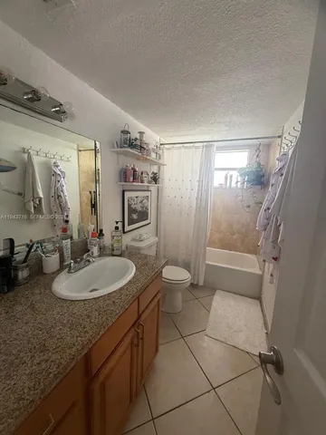 a bedroom with a bed and a workspace