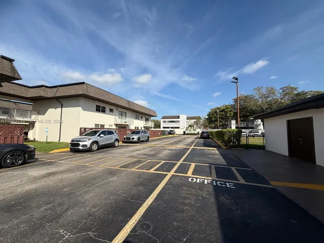 a view of parking with cars parked