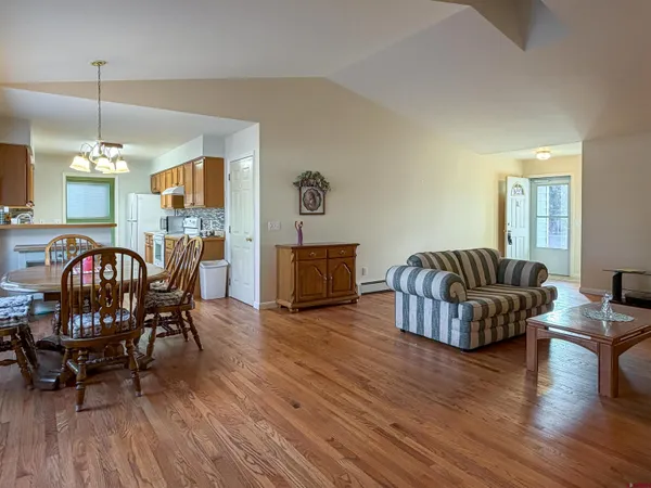 a living room with furniture fireplace and wooden floor