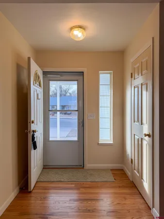 a kitchen with stainless steel appliances granite countertop wooden cabinets a sink and dishwasher with wooden floor