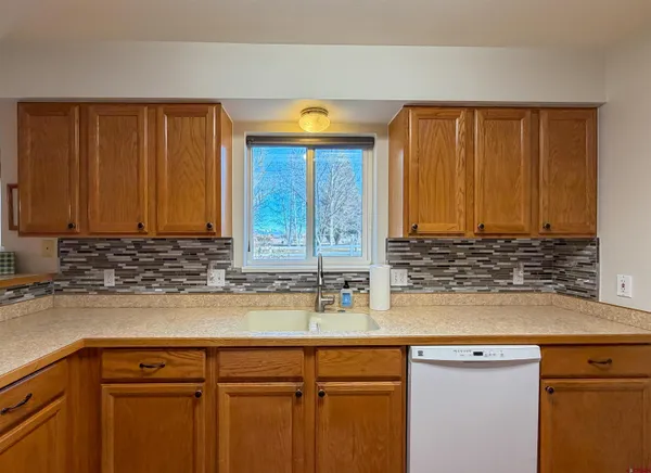a kitchen with a stove top oven cabinets and a refrigerator