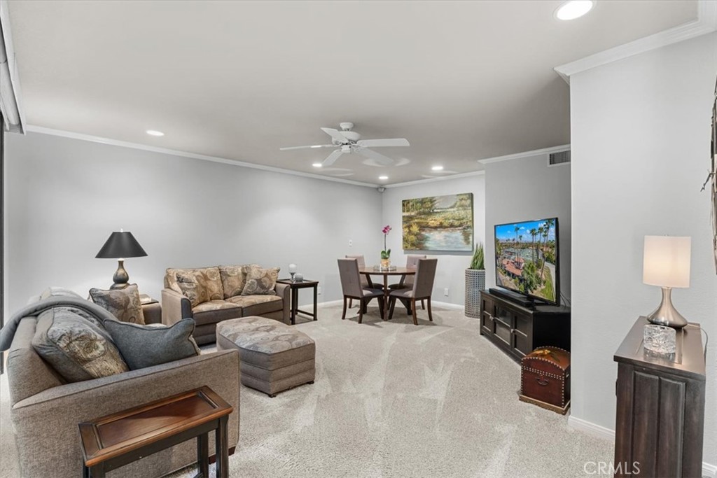 393 Gran Via Palm Desert, CA 92260 - Photo 15 of 60 a living room with furniture and wooden floor
