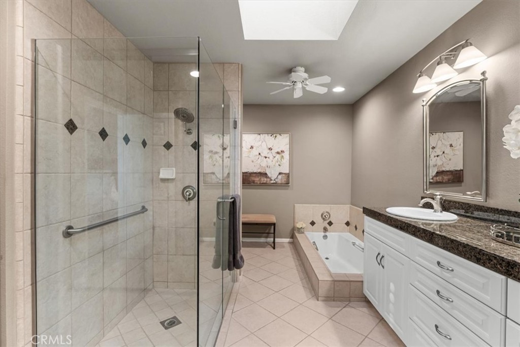 393 Gran Via Palm Desert, CA 92260 - Photo 21 of 60 a spacious bathroom with a granite countertop sink a mirror and shower